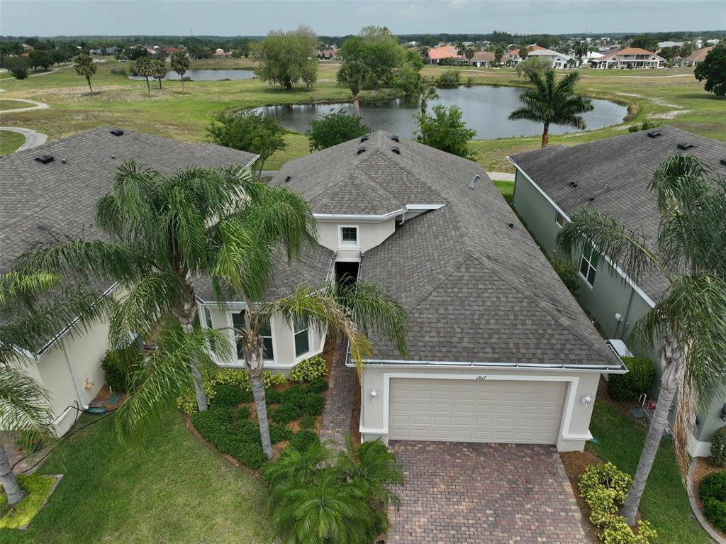 an aerial view of a house with a yard