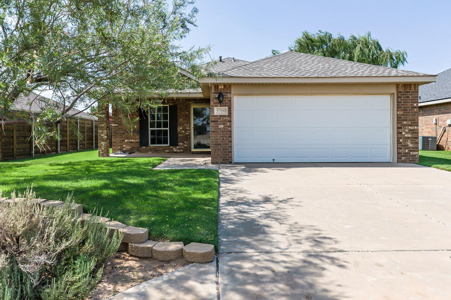 a front view of a house with a yard and an outdoor seating