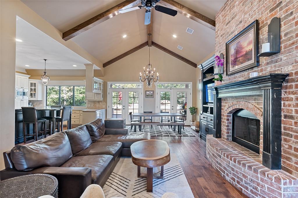 a living room with furniture a fireplace and a chandelier