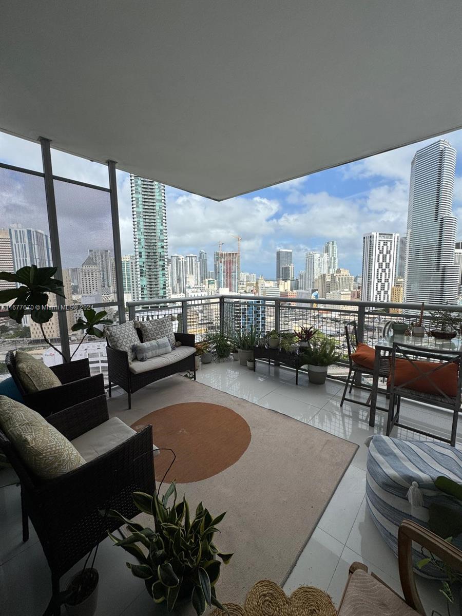 a living room with lots of furniture and a large window