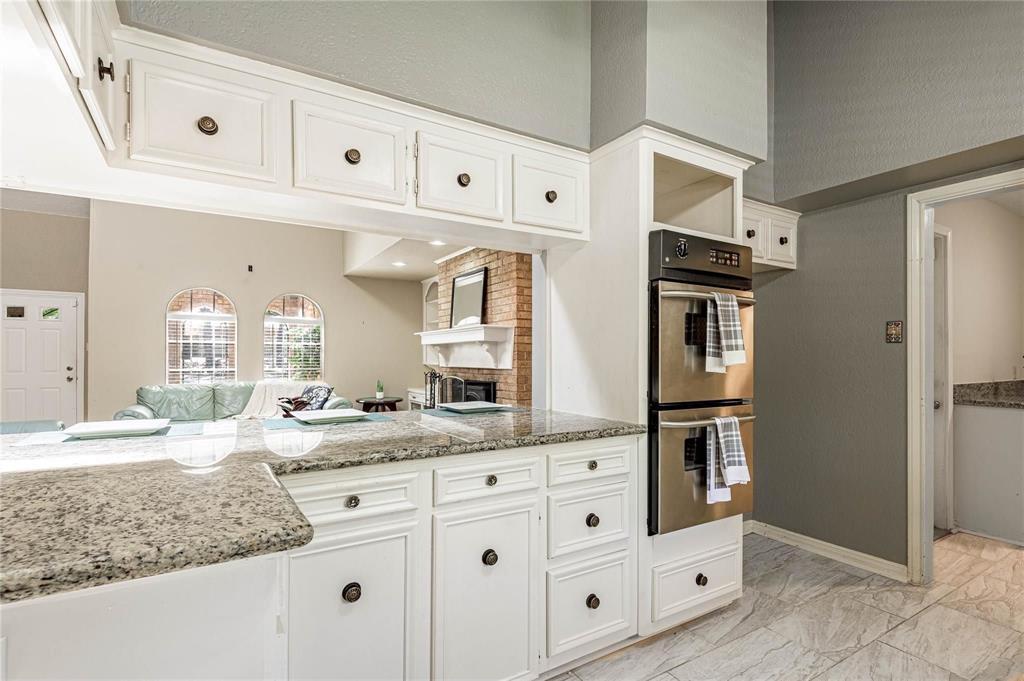 a bathroom with cabinets appliances and a sink