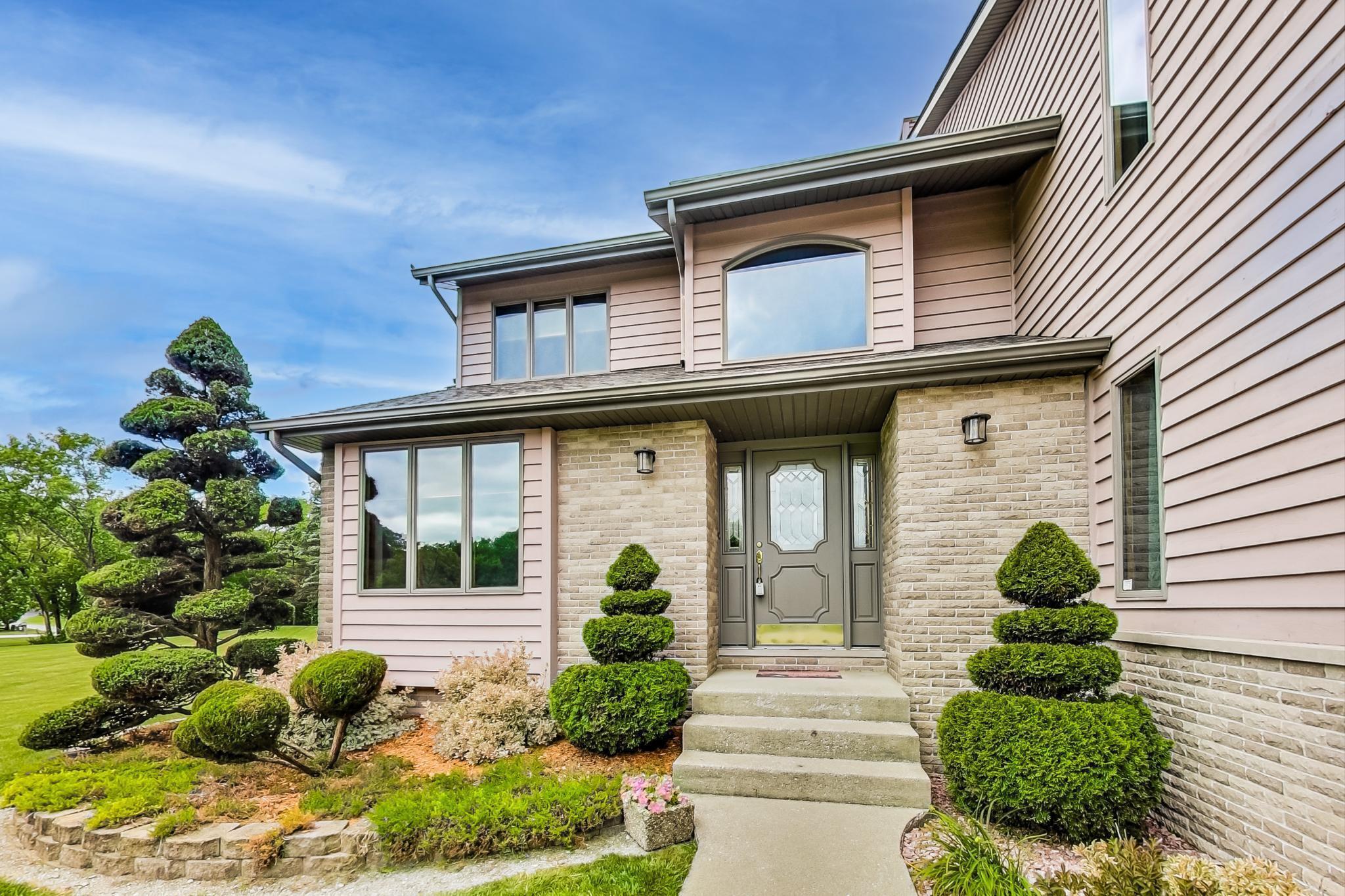 a front view of a house with garden