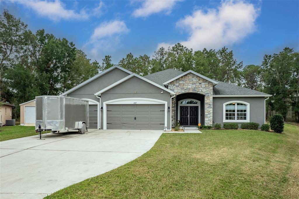 a front view of a house with a yard and garage