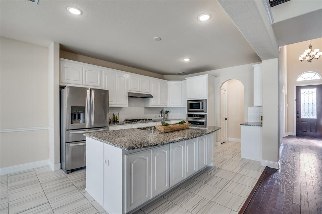 a kitchen with stainless steel appliances granite countertop a stove oven and a refrigerator