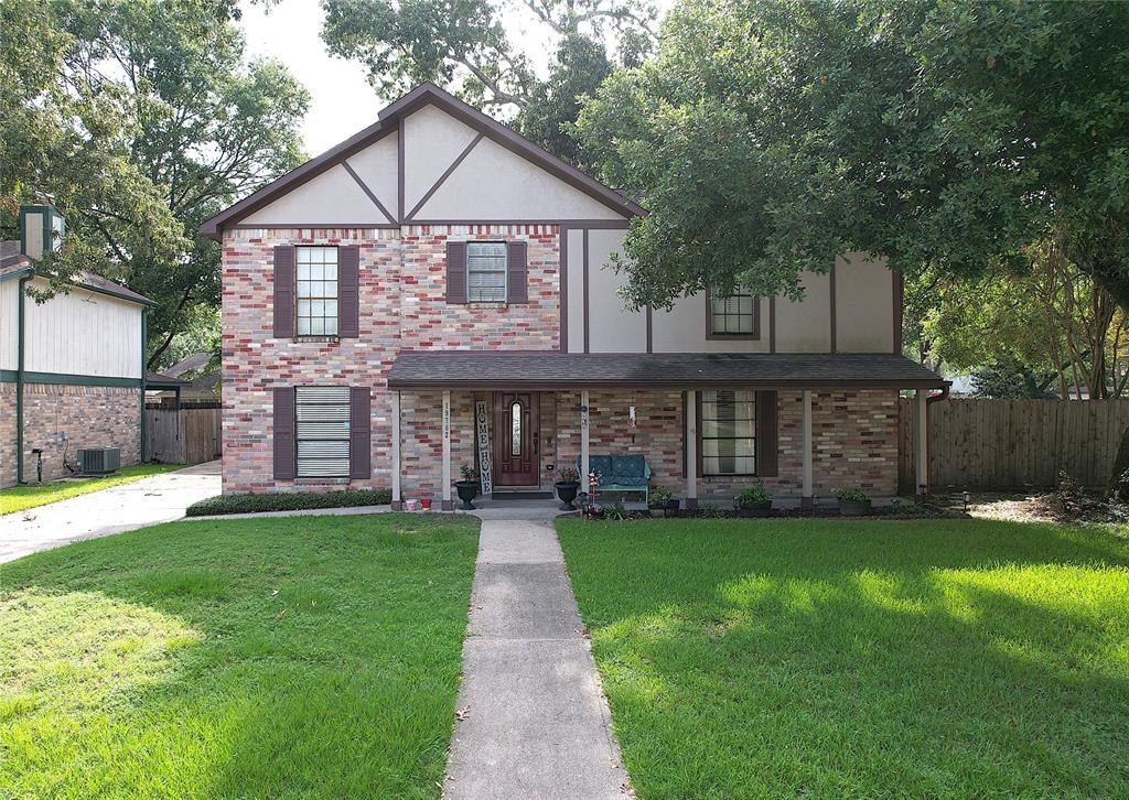 a front view of a house with a yard and trees