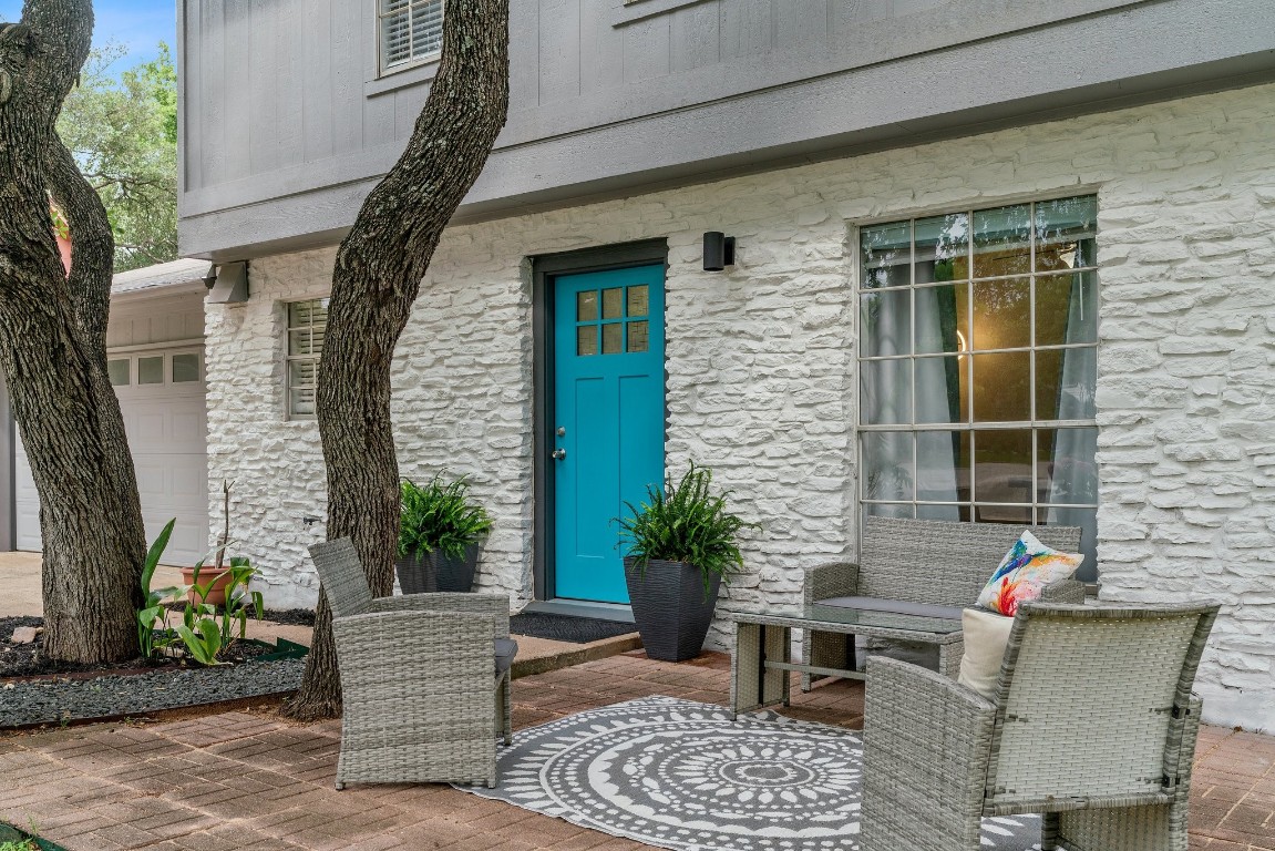 a balcony with furniture and a potted plant