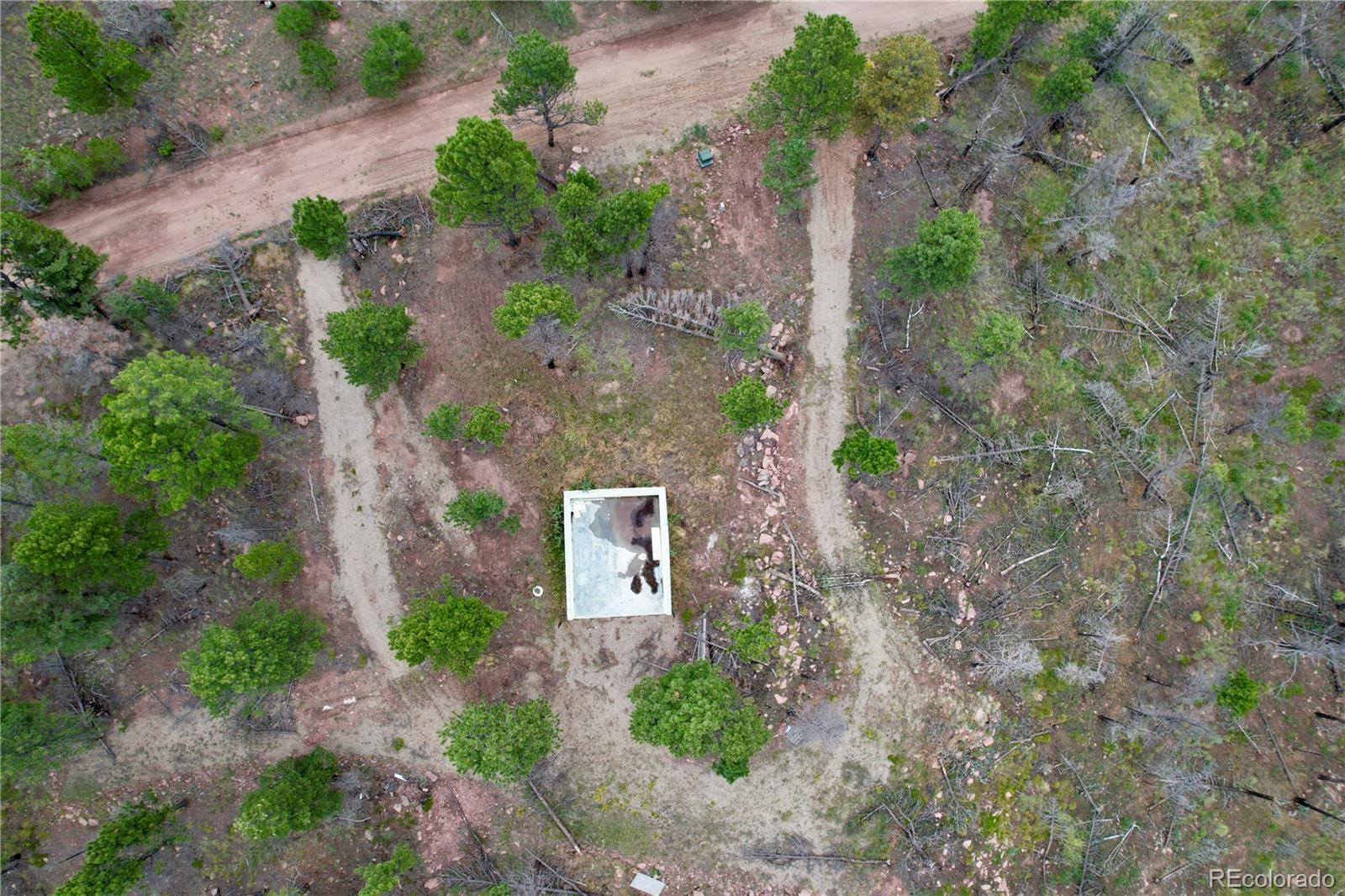 a aerial view of a house with a yard and tree s