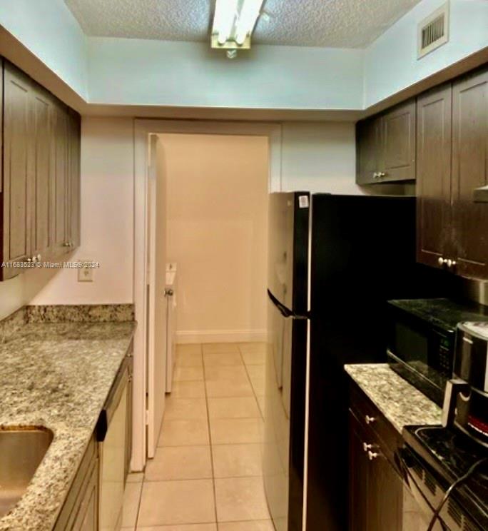 a kitchen with a refrigerator and a stove