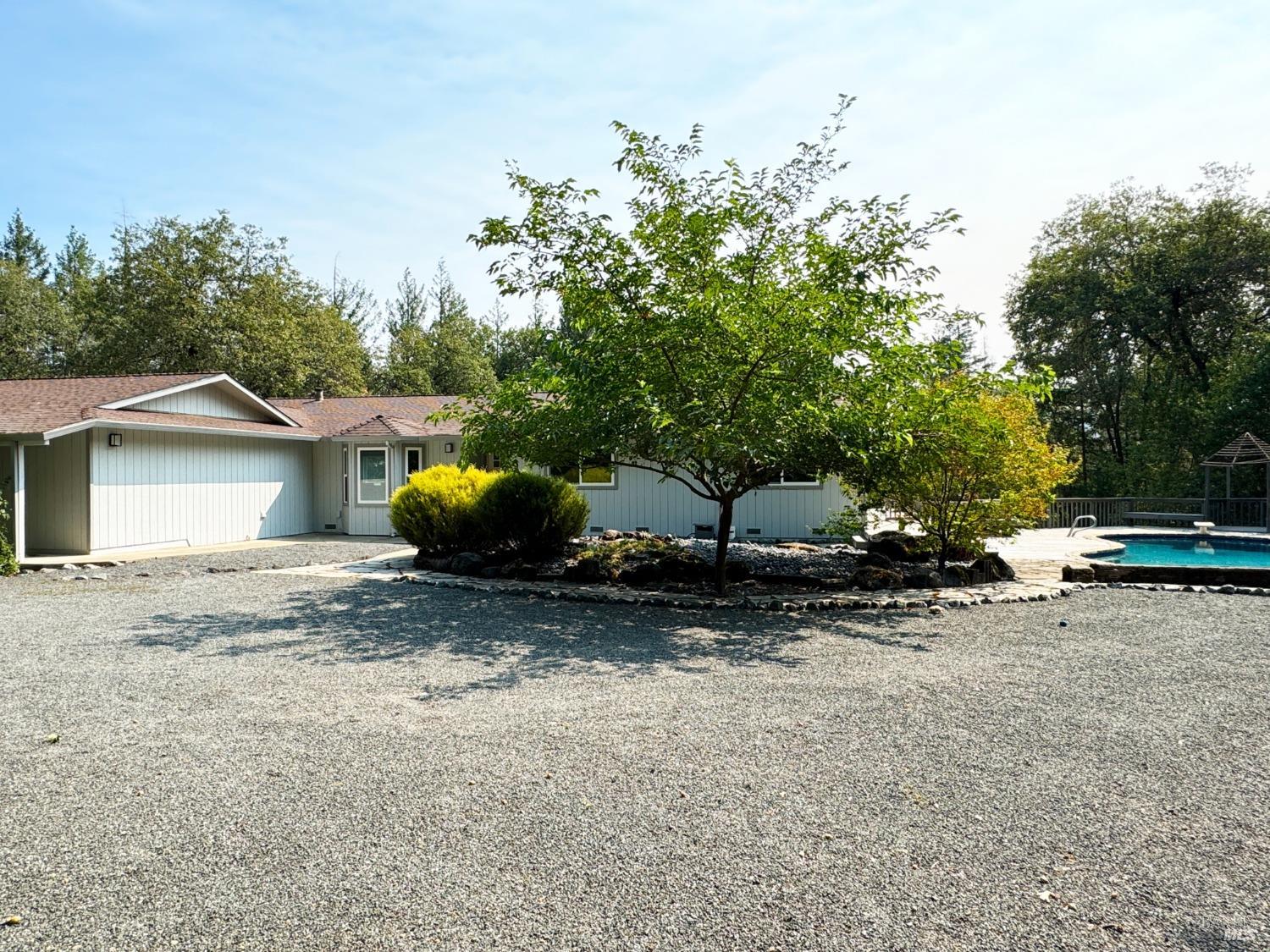 a view of a house with a yard and sitting area