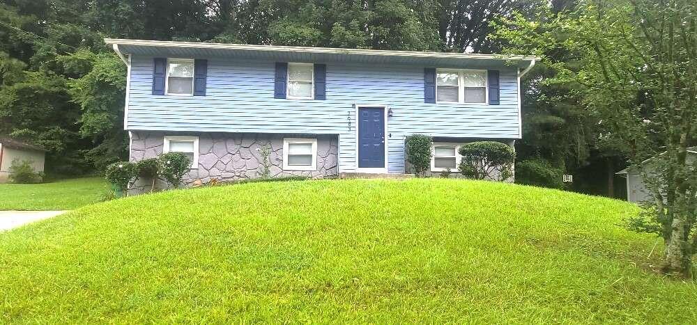 a front view of house with yard and green space