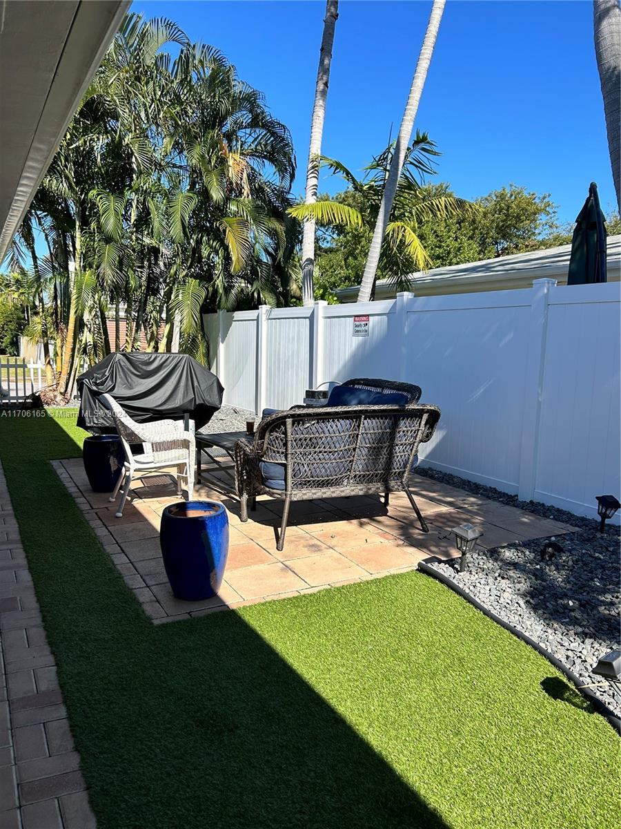 a view of a backyard with sitting area