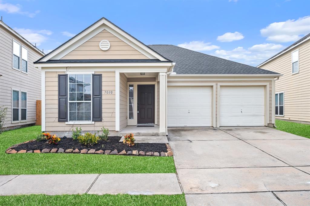 a front view of a house with a yard and garage