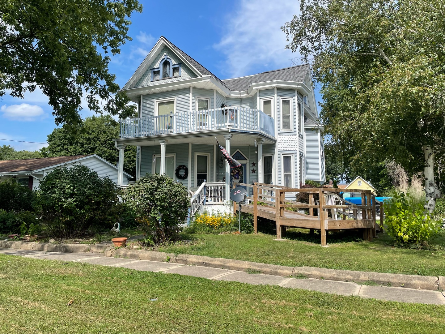 a front view of a house with garden and porch