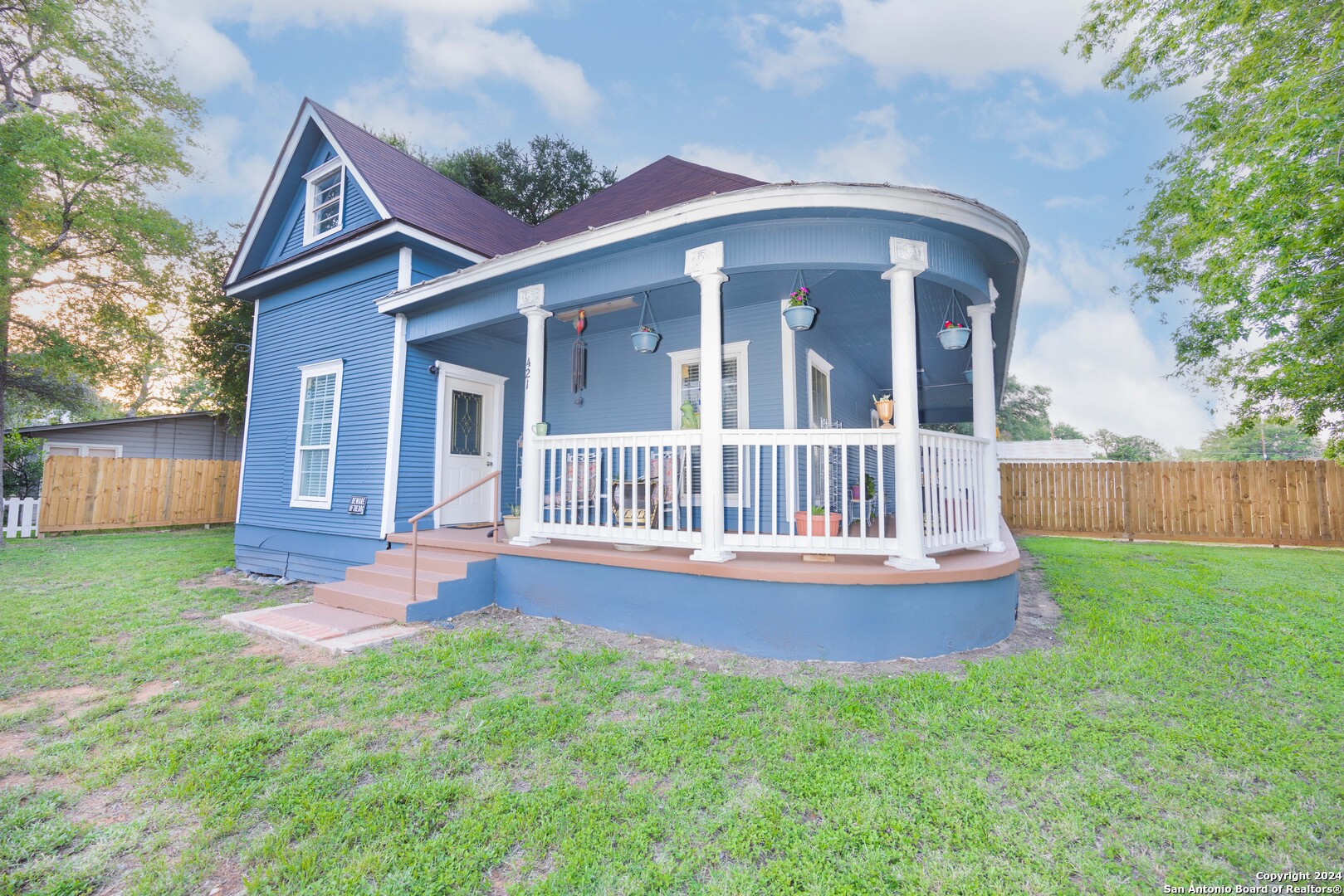 a view of a house with a yard and deck