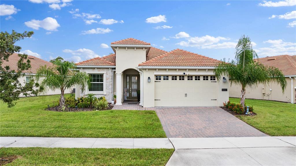 a front view of a house with a yard and garage