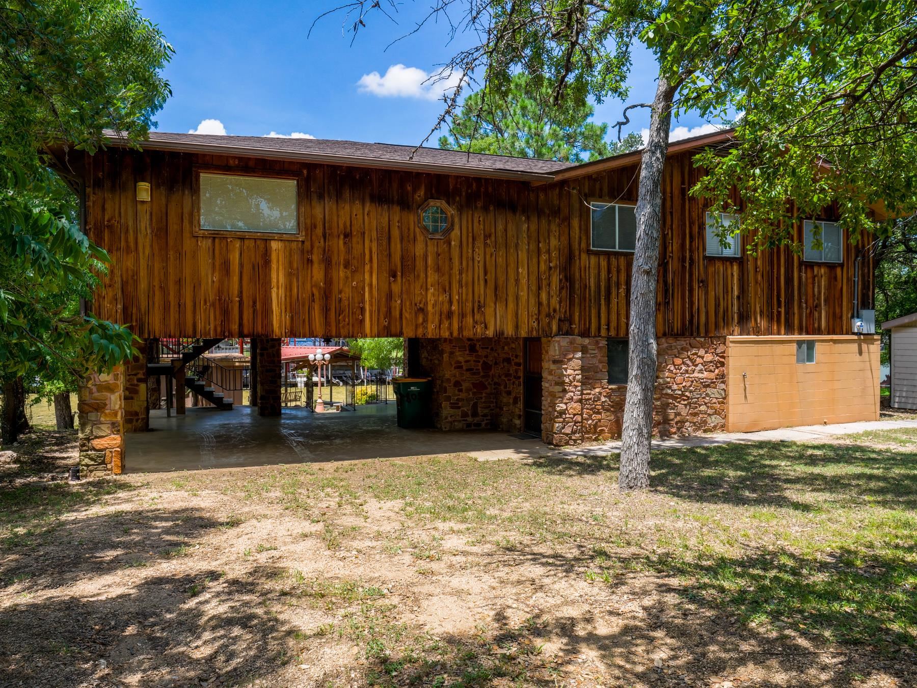 a backyard of a house with barbeque oven