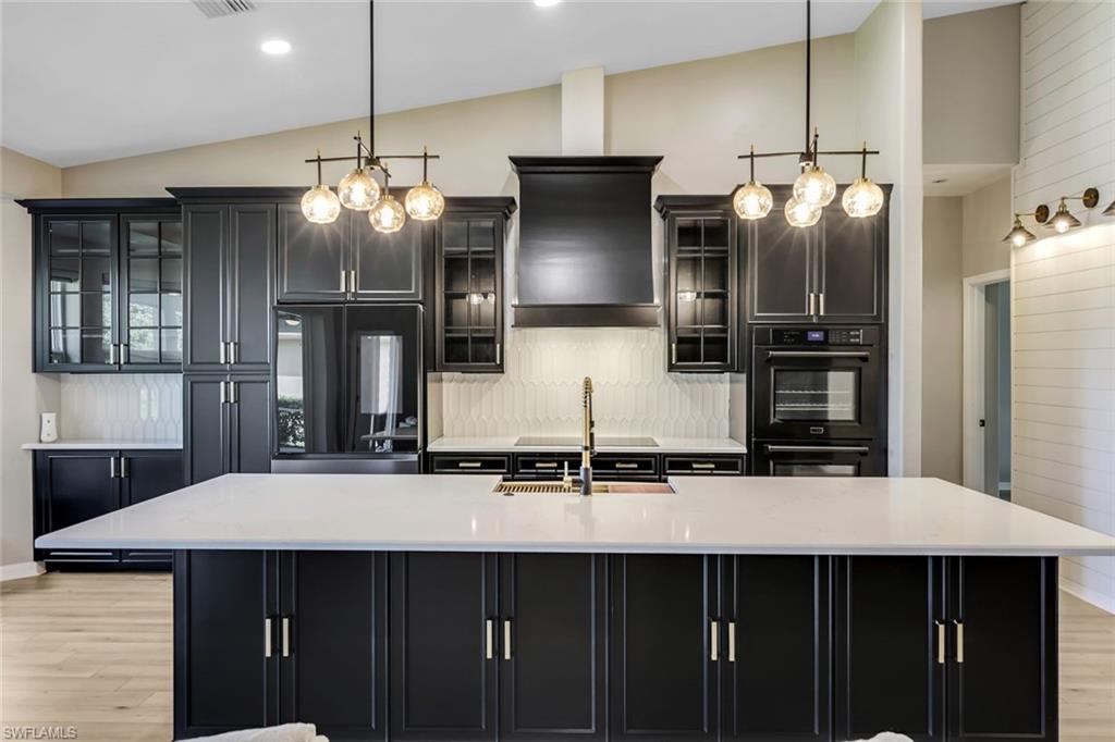 a kitchen with stainless steel appliances a sink and a refrigerator