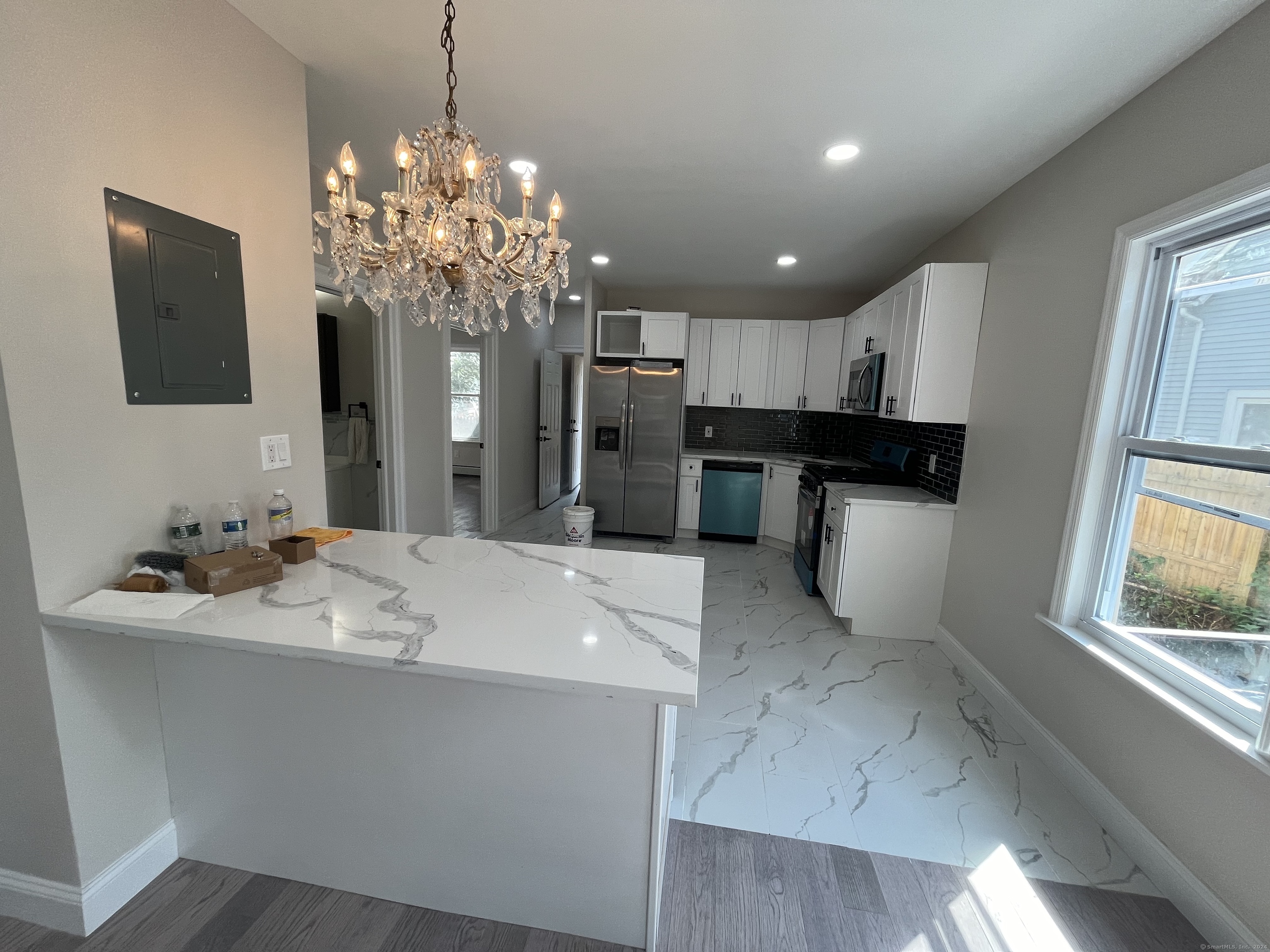 a kitchen with kitchen island granite countertop stainless steel appliances a sink stove and refrigerator