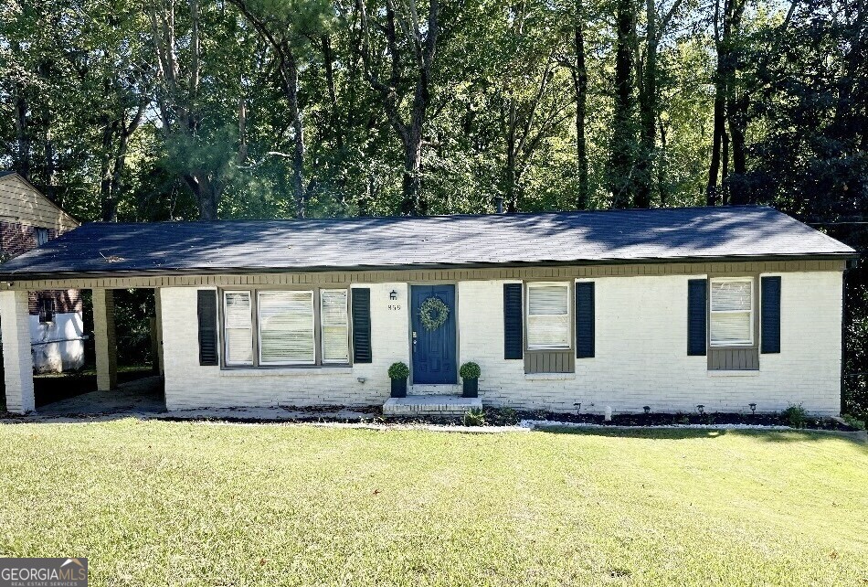 a front view of a house with a yard outdoor seating and garage