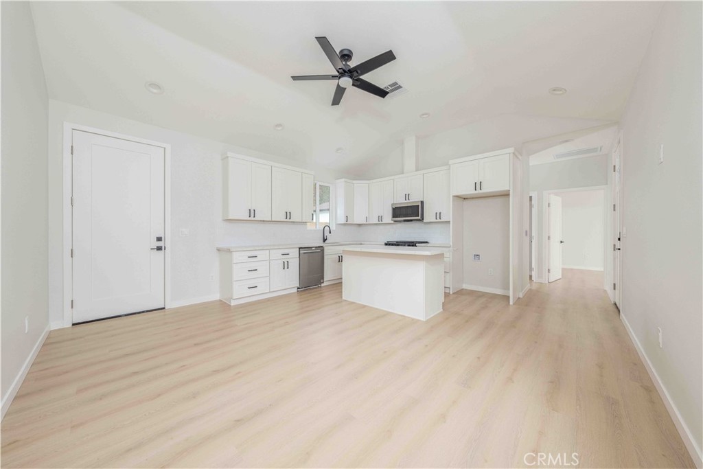 a view of kitchen with sink and refrigerator