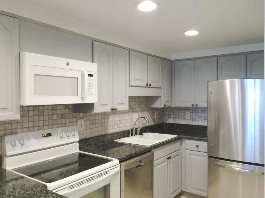 a kitchen with a sink stove and refrigerator