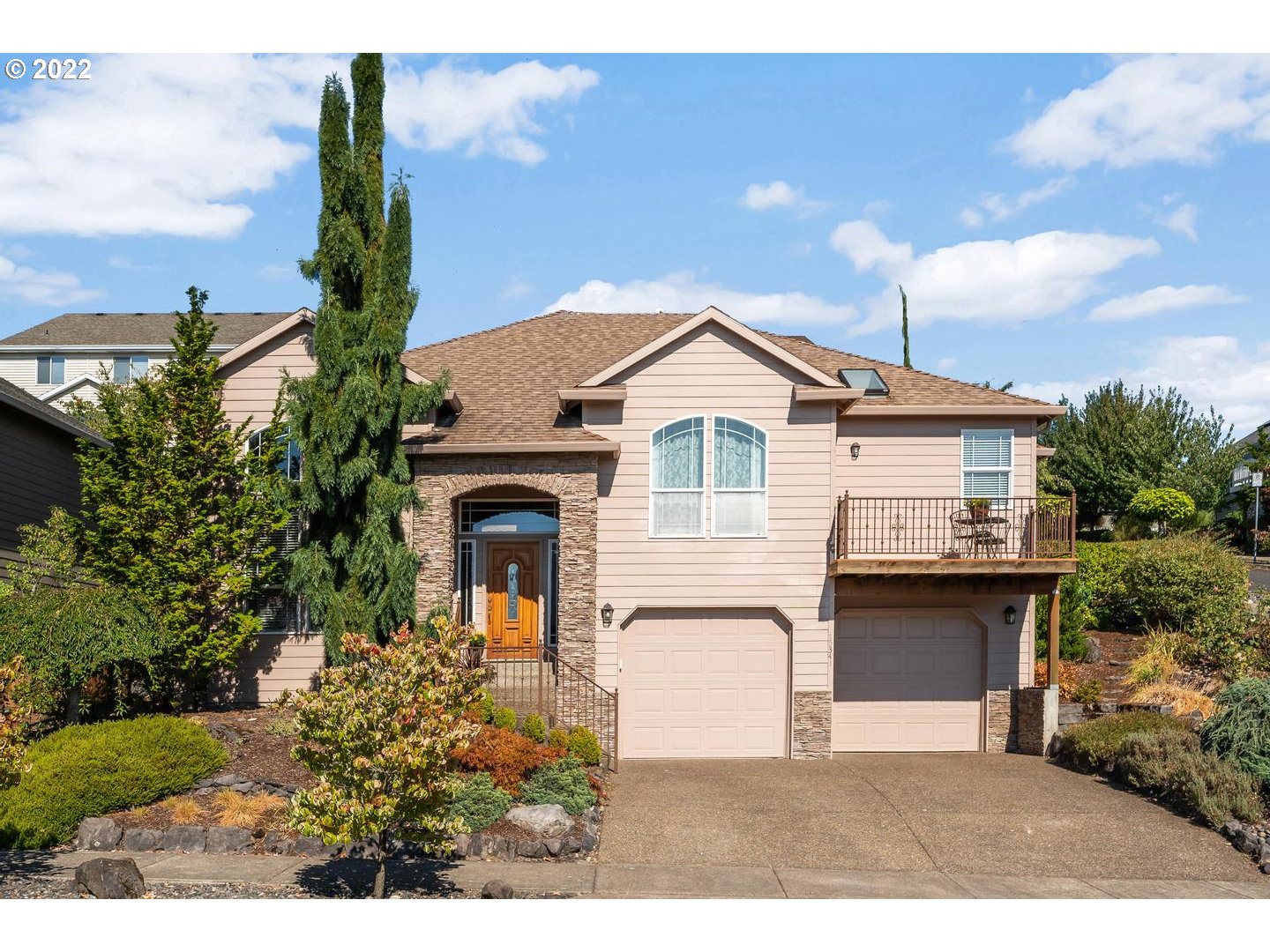 a front view of a house with a garden