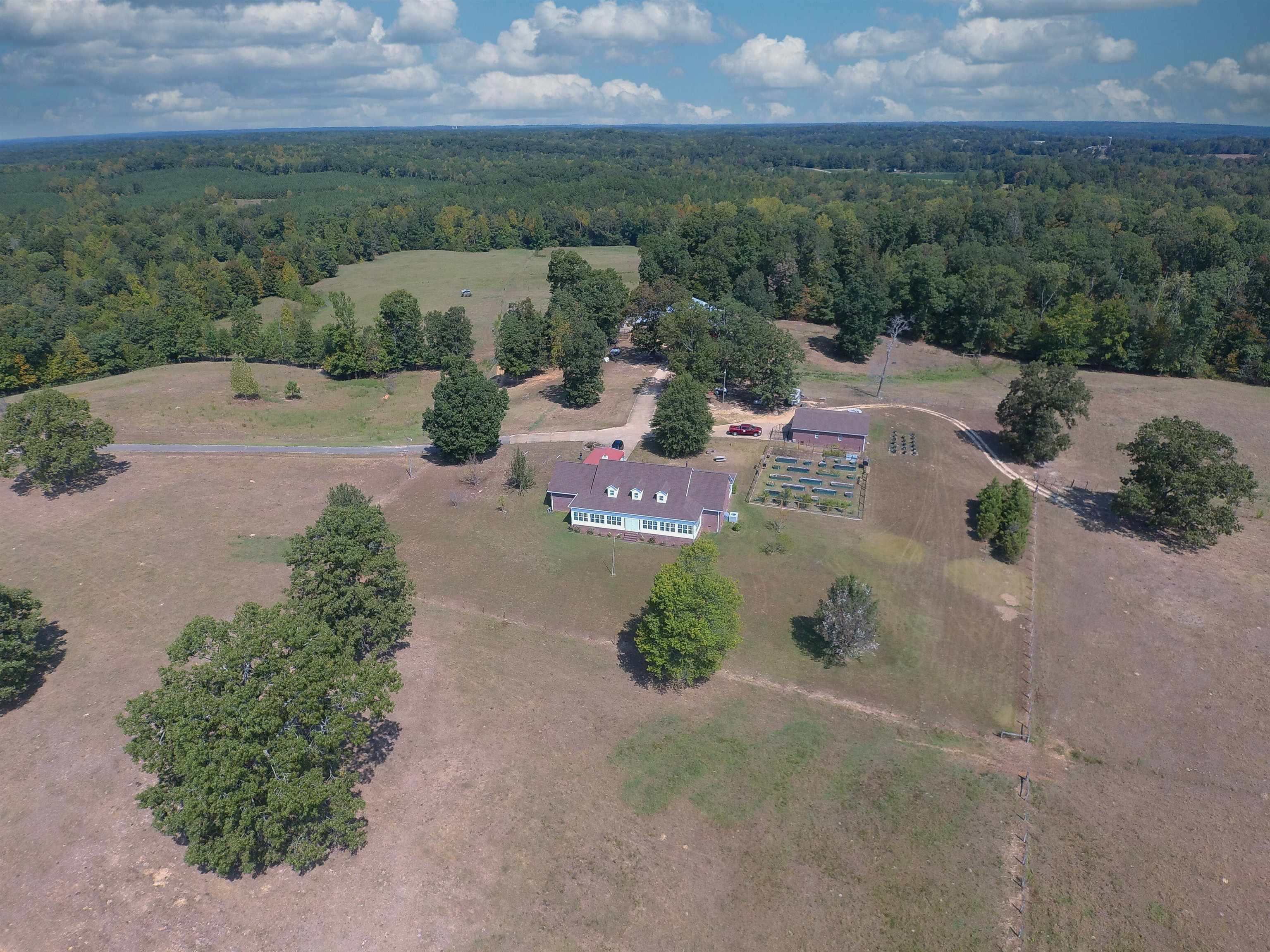 an aerial view of a house with a yard