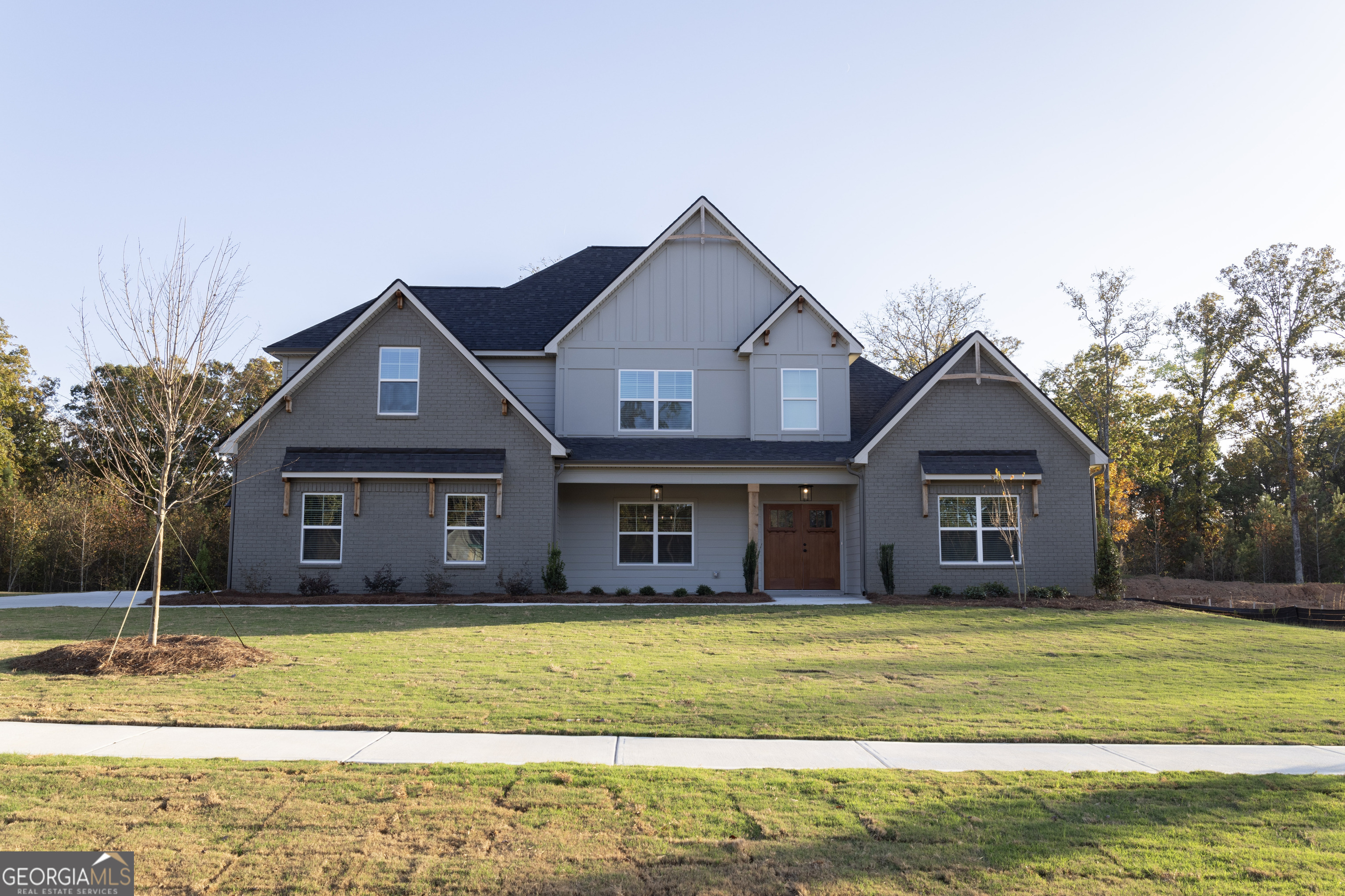 a front view of a house with a garden