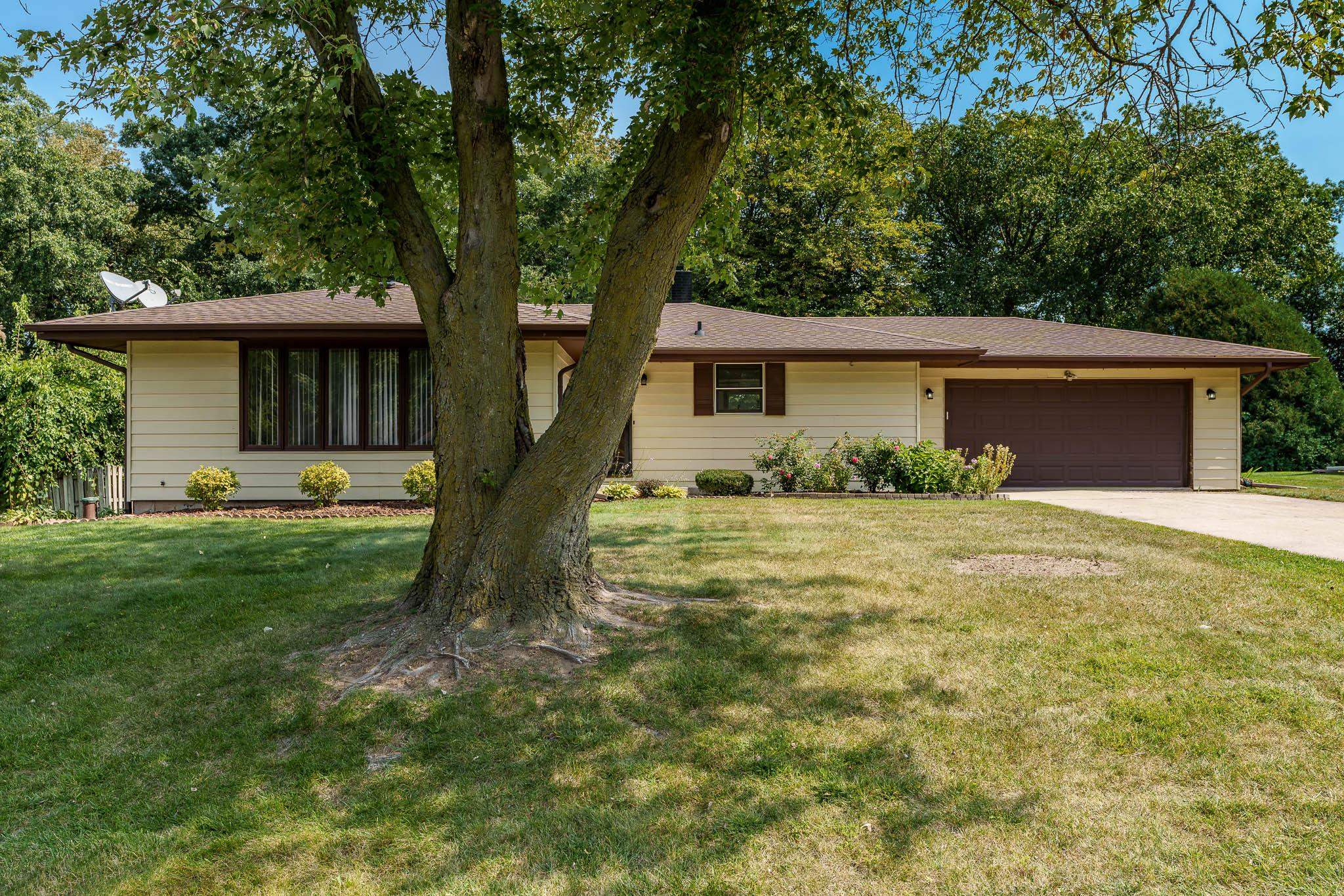 a front view of house with yard and green space