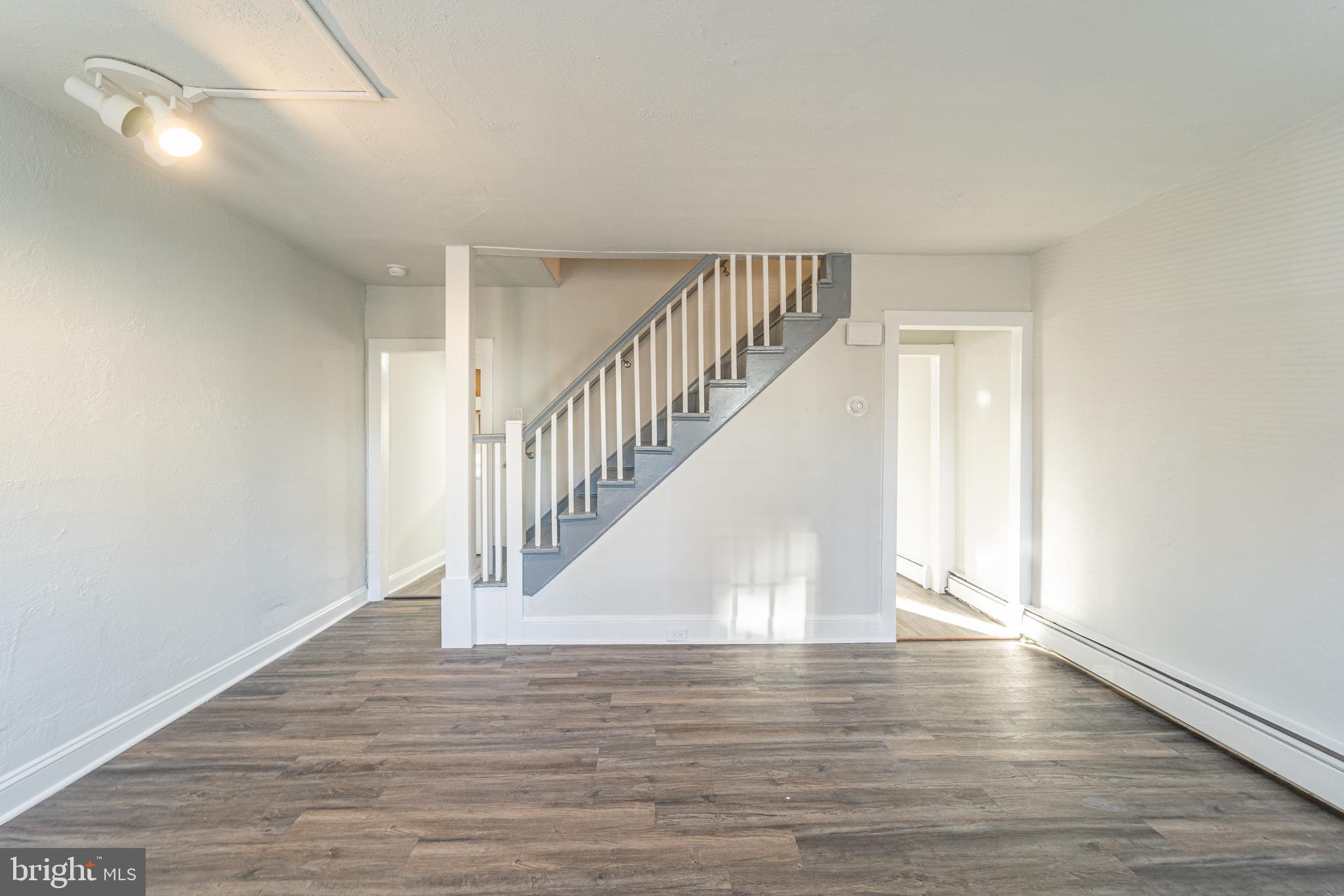 a view of entryway and hall with wooden floor