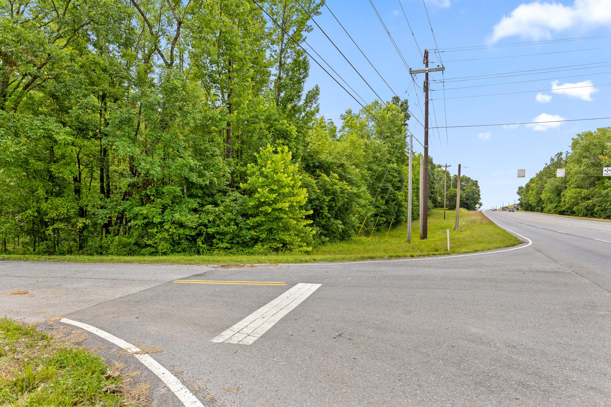 a view of a road with a small yard