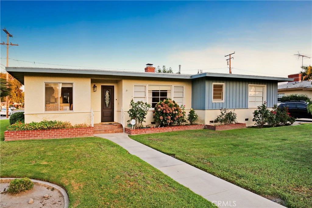 a front view of house with yard and outdoor seating