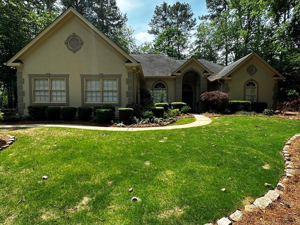 a front view of house with yard and green space