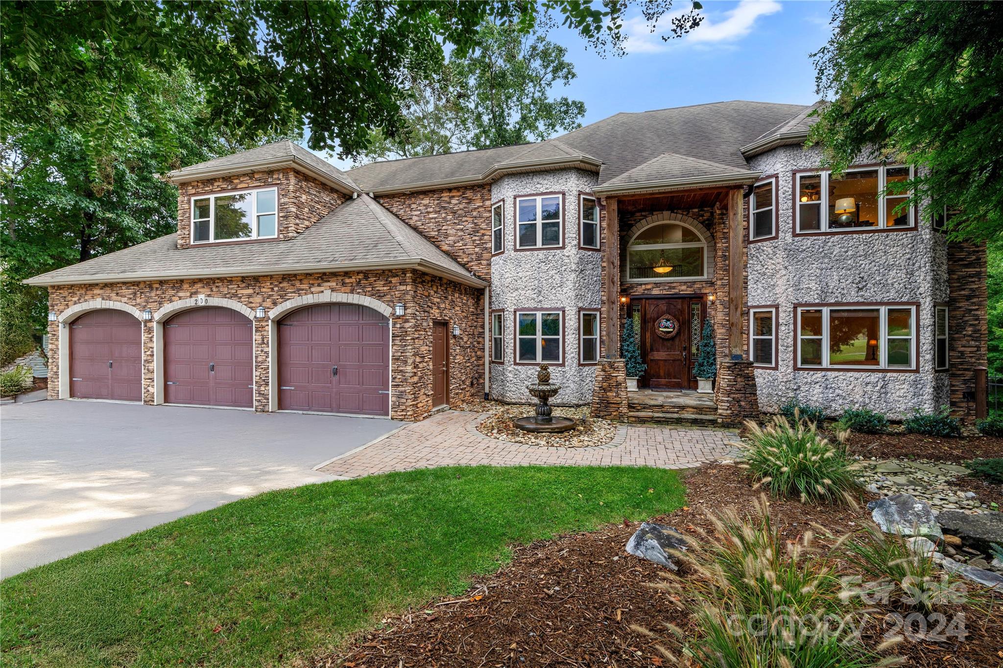 a front view of a house with patio and garden