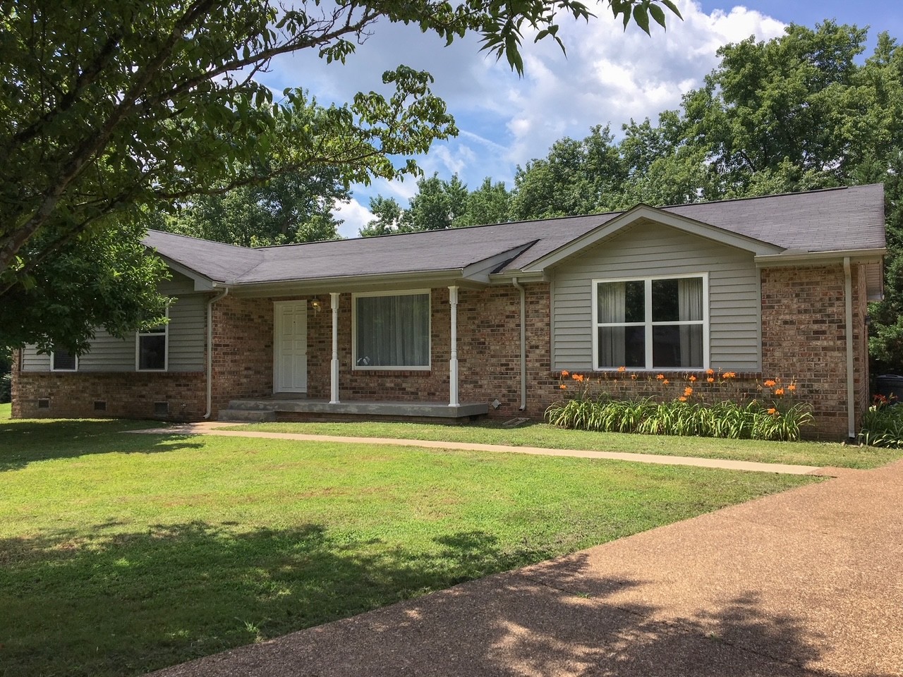 a front view of a house with a yard