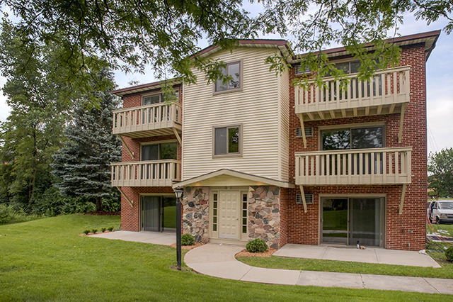 a view of a house with a garden and deck