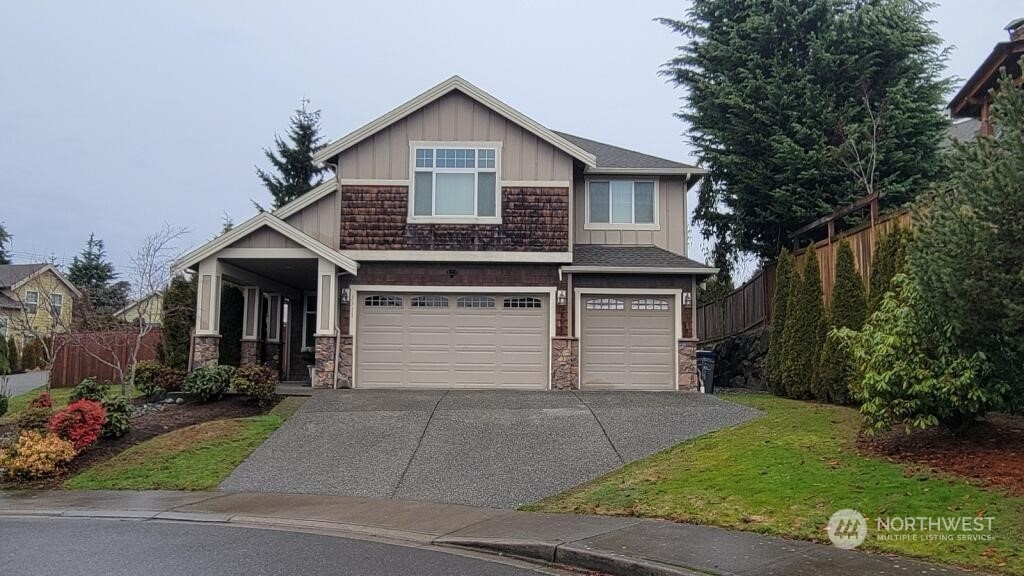 a front view of a house with a yard and garage