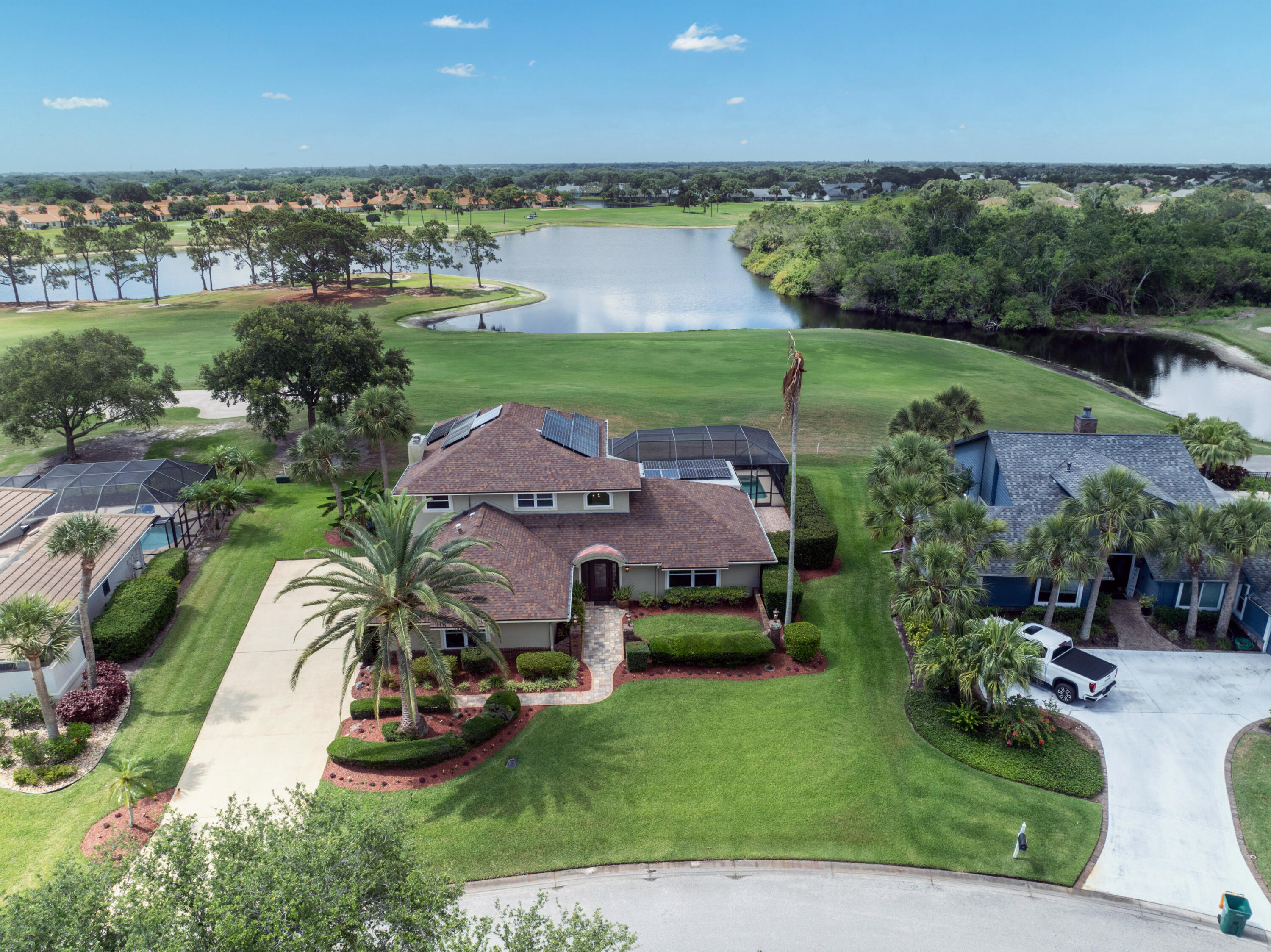 an aerial view of a house with garden space and a swimming pool