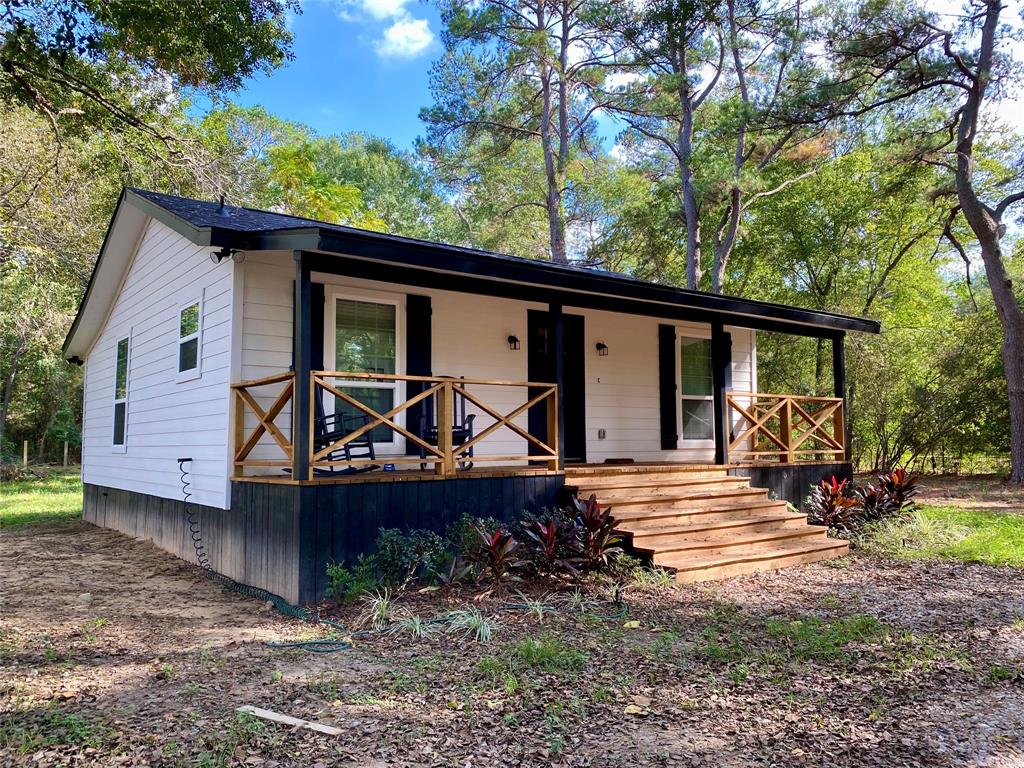 a view of a house with backyard sitting area and garden