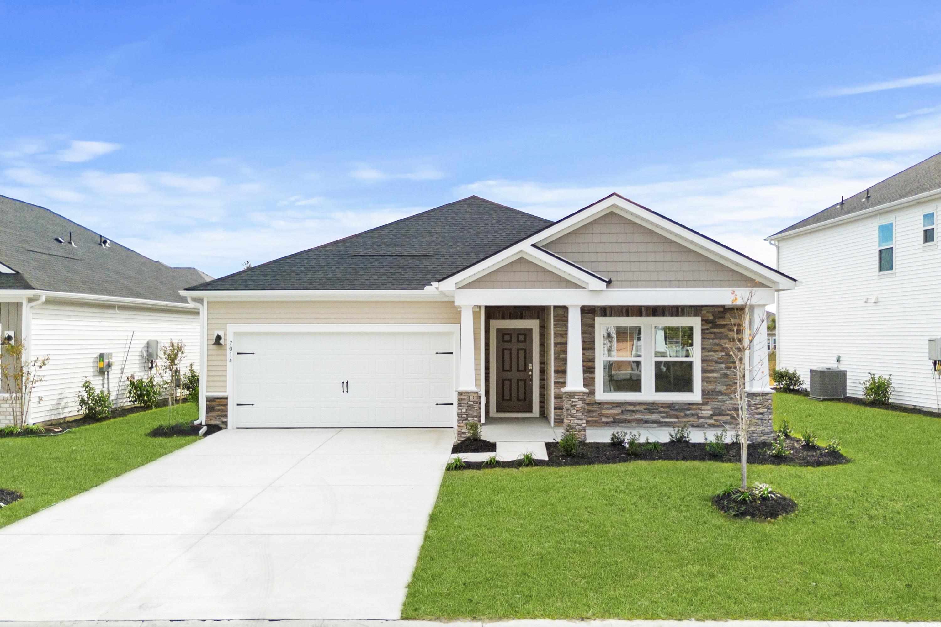 Craftsman inspired home with a front yard, a garag