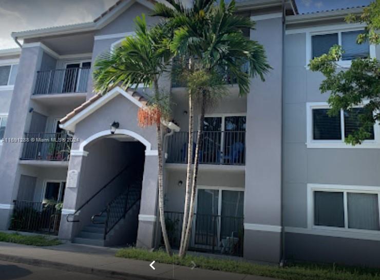 a house with palm tree in front of it