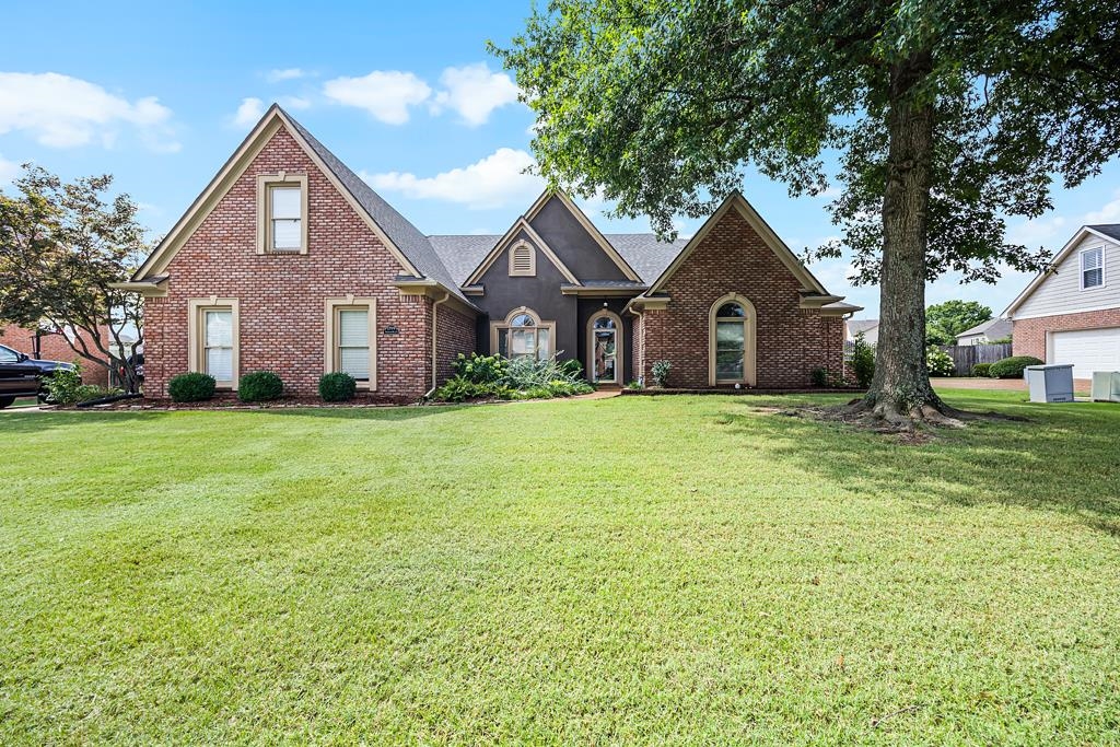 a front view of house with yard and green space