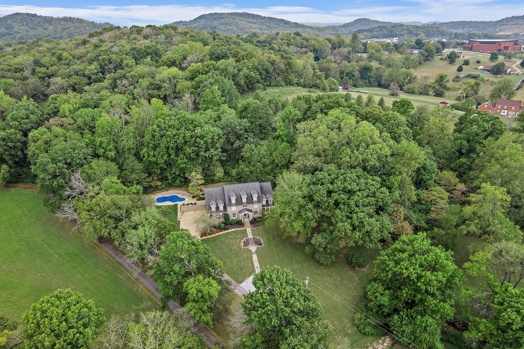 an aerial view of a house with a yard