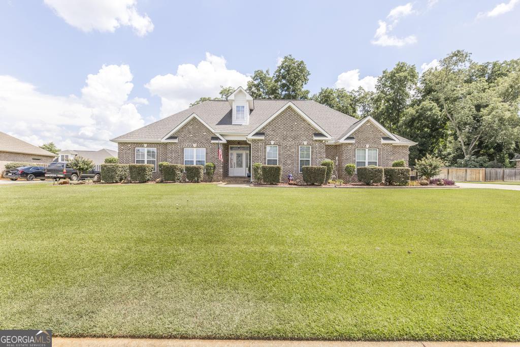 a front view of house with yard and green space