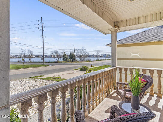 a view of a balcony with wooden floor