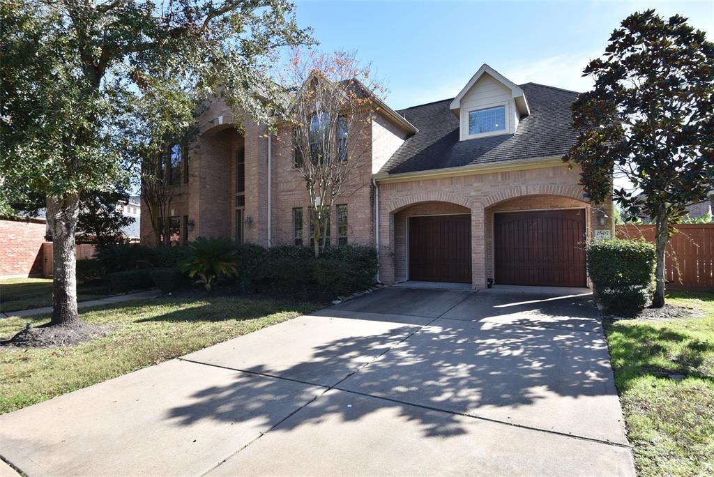 a front view of a house with a yard and a garage