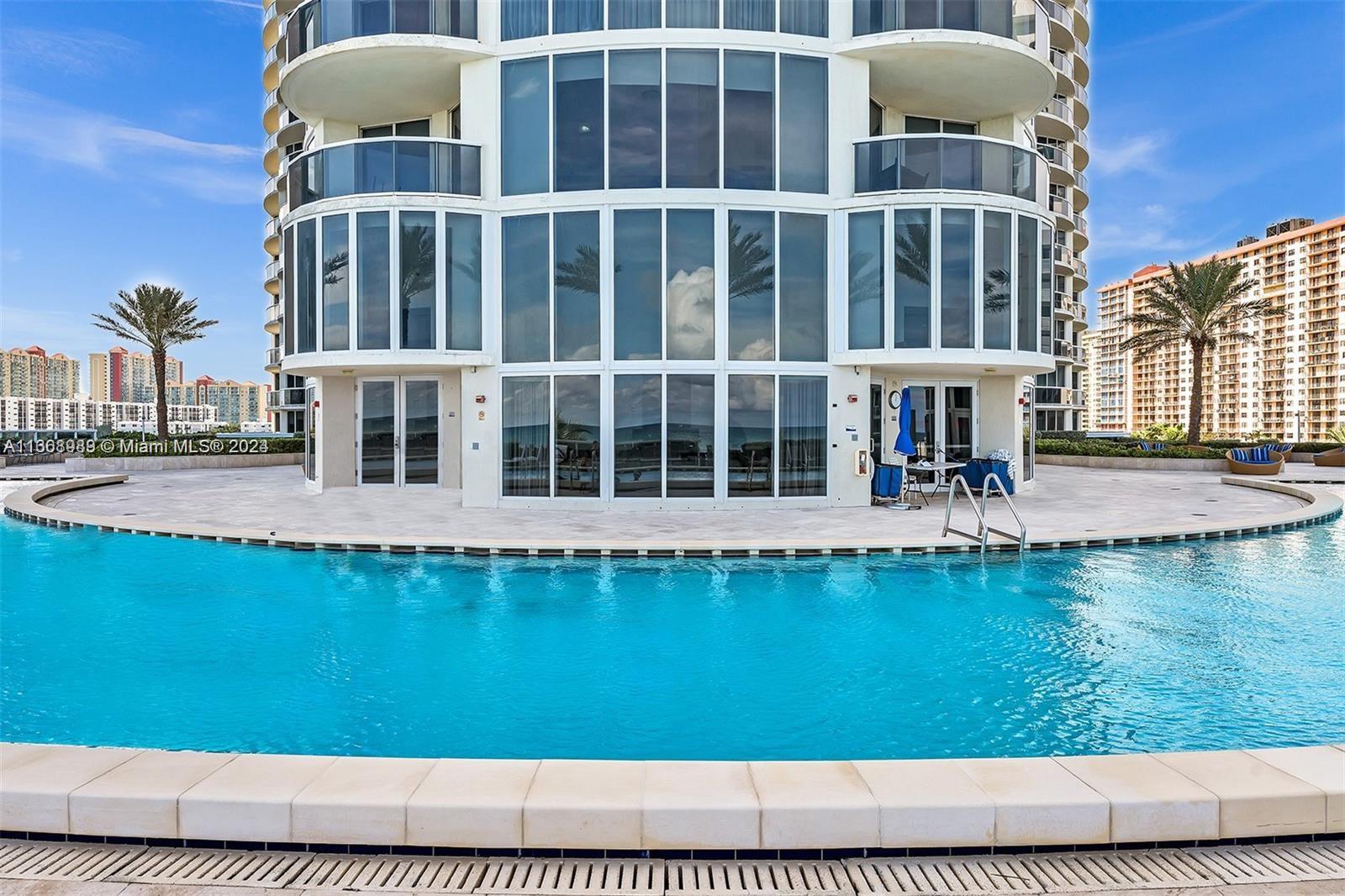 a view of a large building with a swimming pool