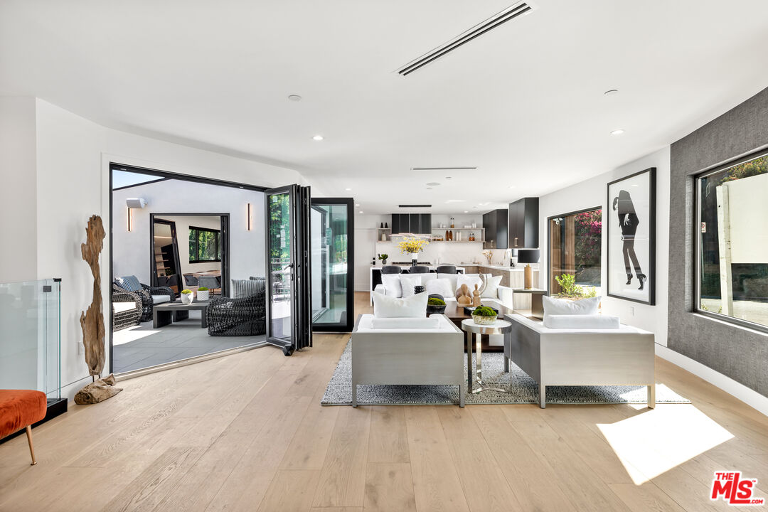 a living room with furniture and large windows