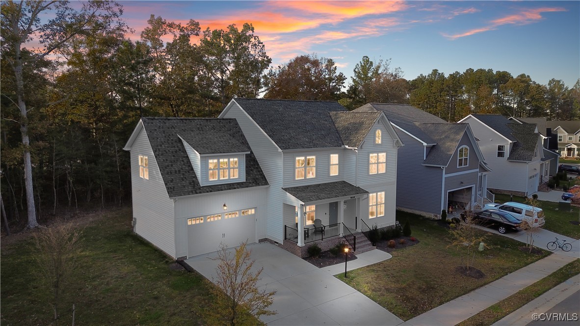 View of front facade with a garage, a porch, and a