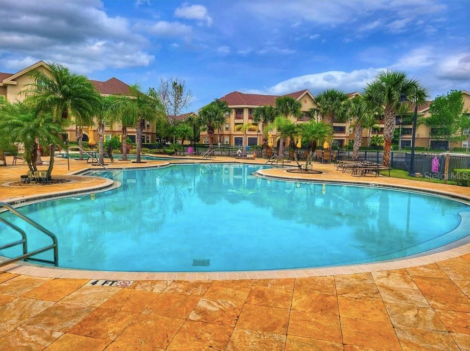 a view of swimming pool with outdoor seating and a garden